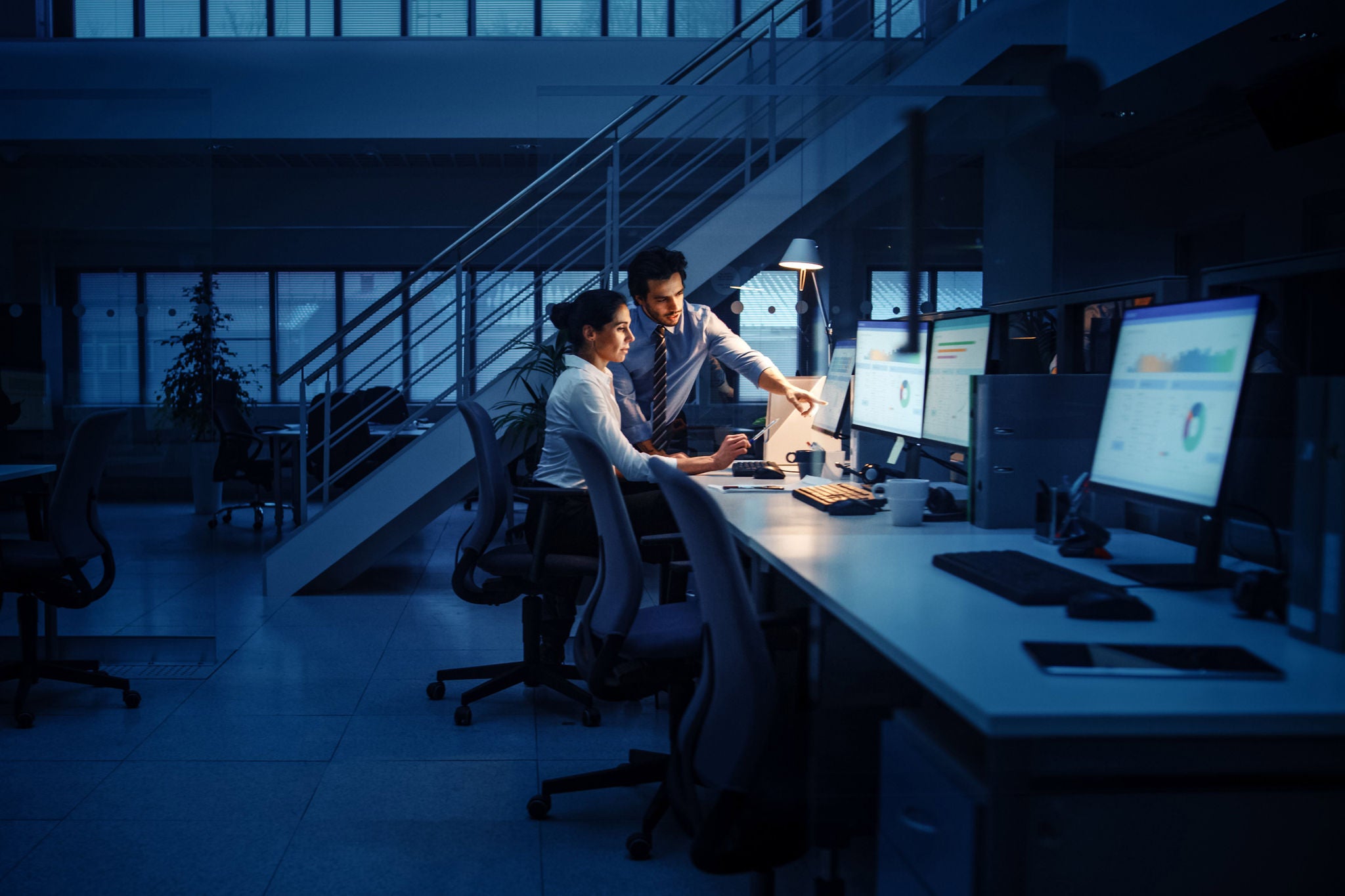 Modern office team reviewing crypto compliance documents on laptops and tablets for business account setup in 2024